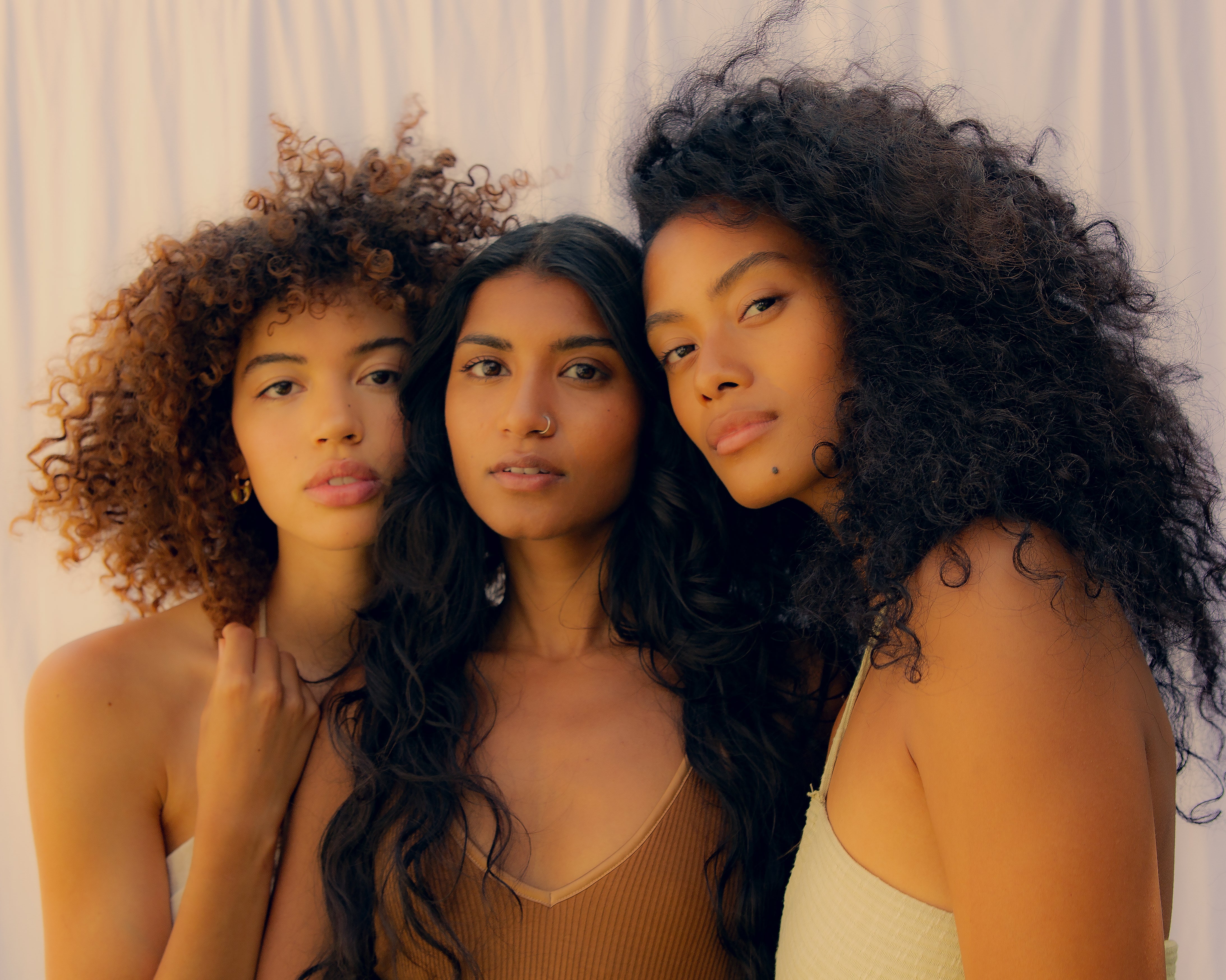 three women of color with beautiful hair